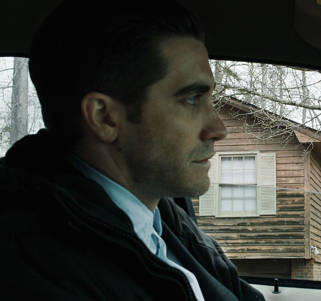 Jake Gyllenhaal in car watching