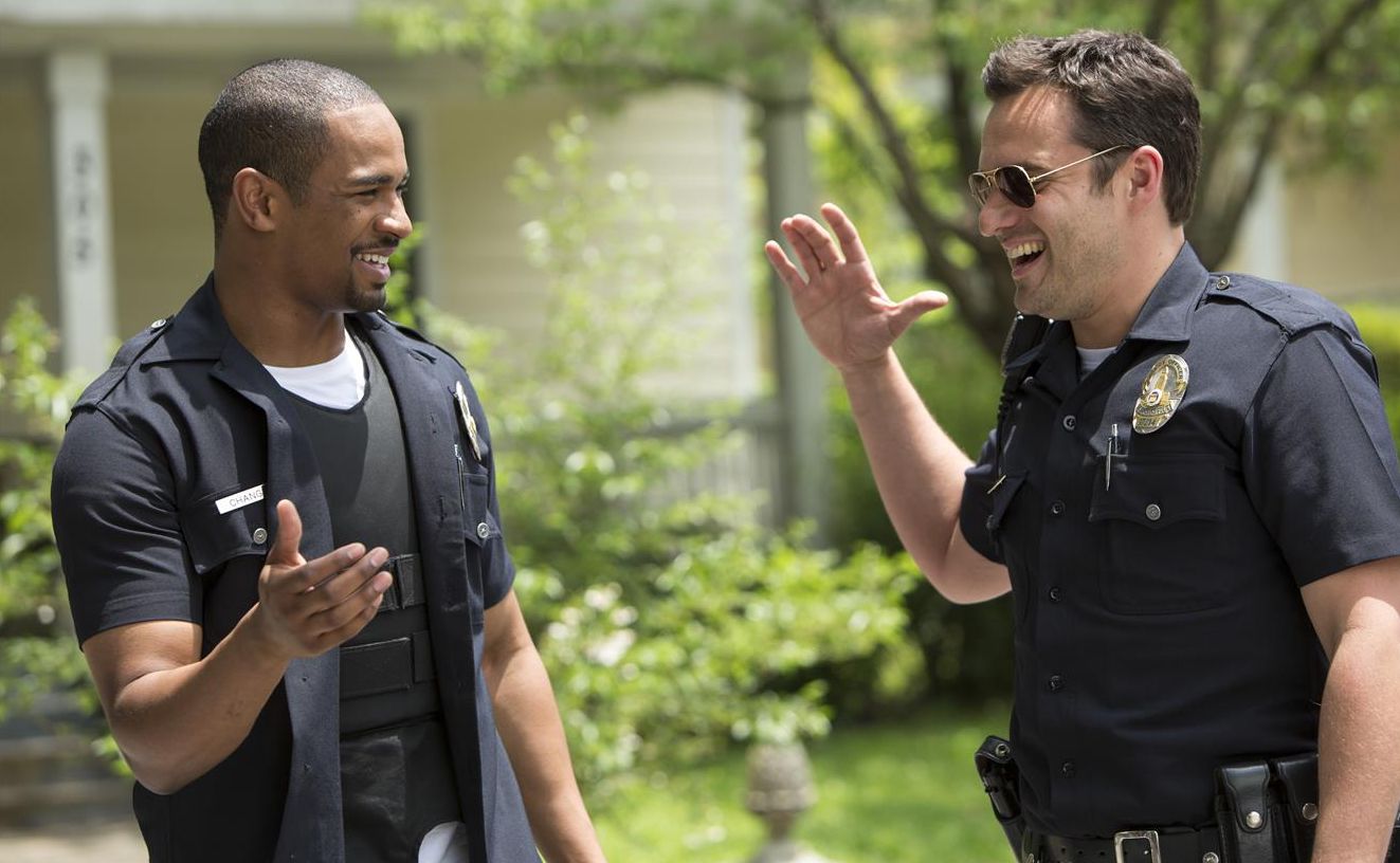 Jake Johnson and Damon Wayans Jr. high five in their uniform