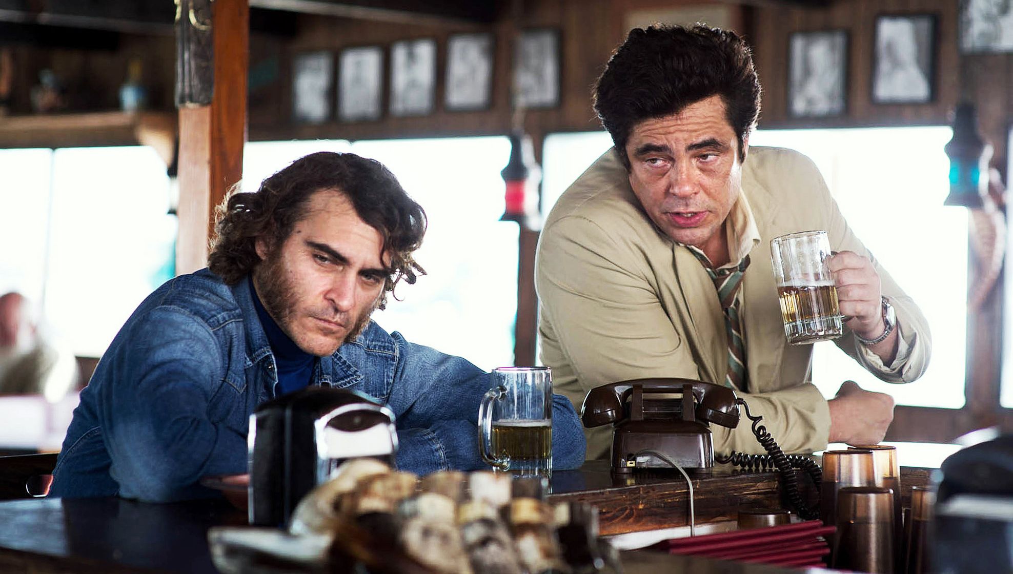 Joaquin Phoenix and Benicio Del Toro have a drink in Inheren