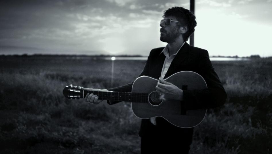 Gruff Rhys performing on guitar