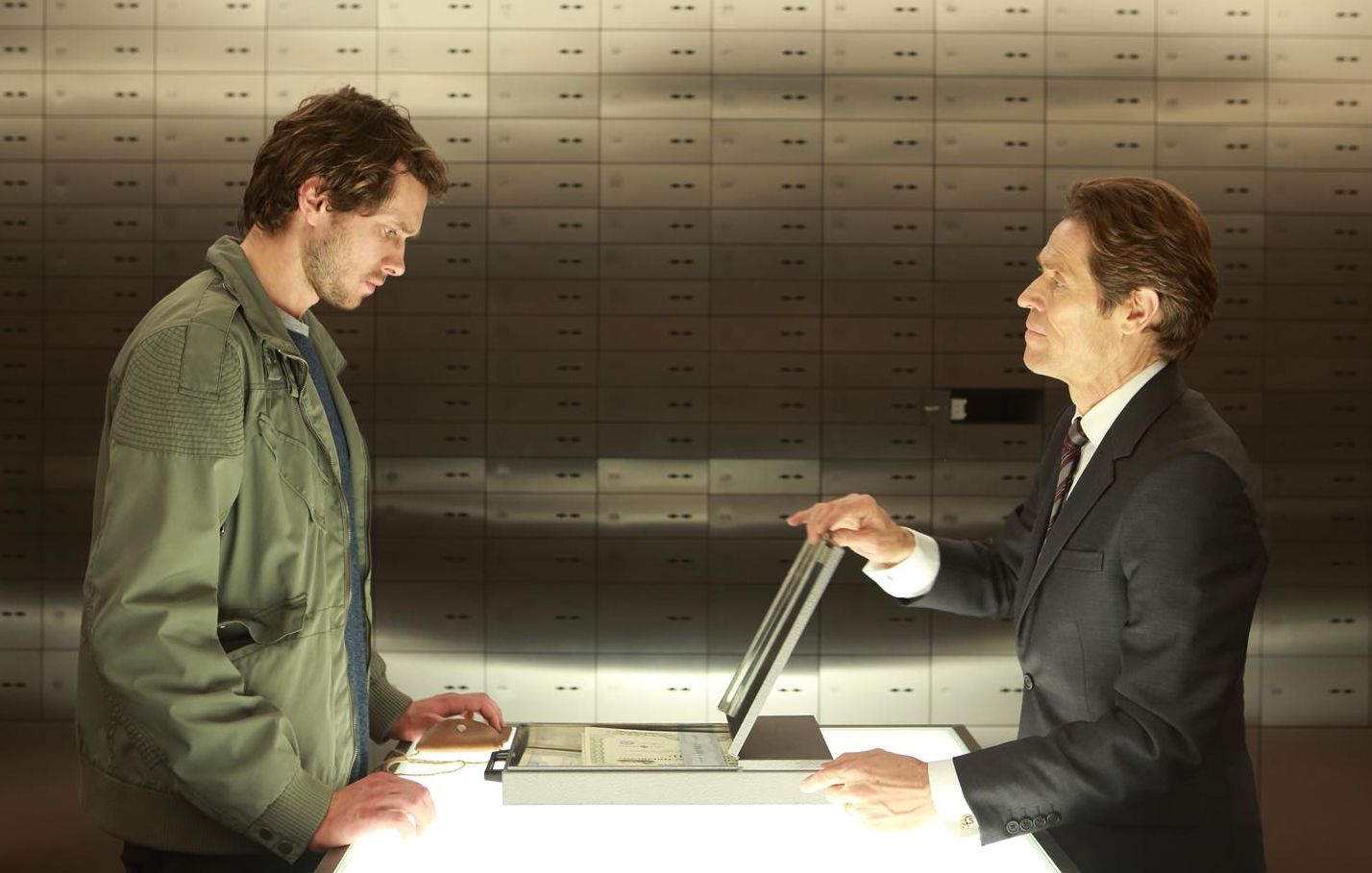 Willem Dafoe as banker providing Grigoriy Dobrygin as Issa K