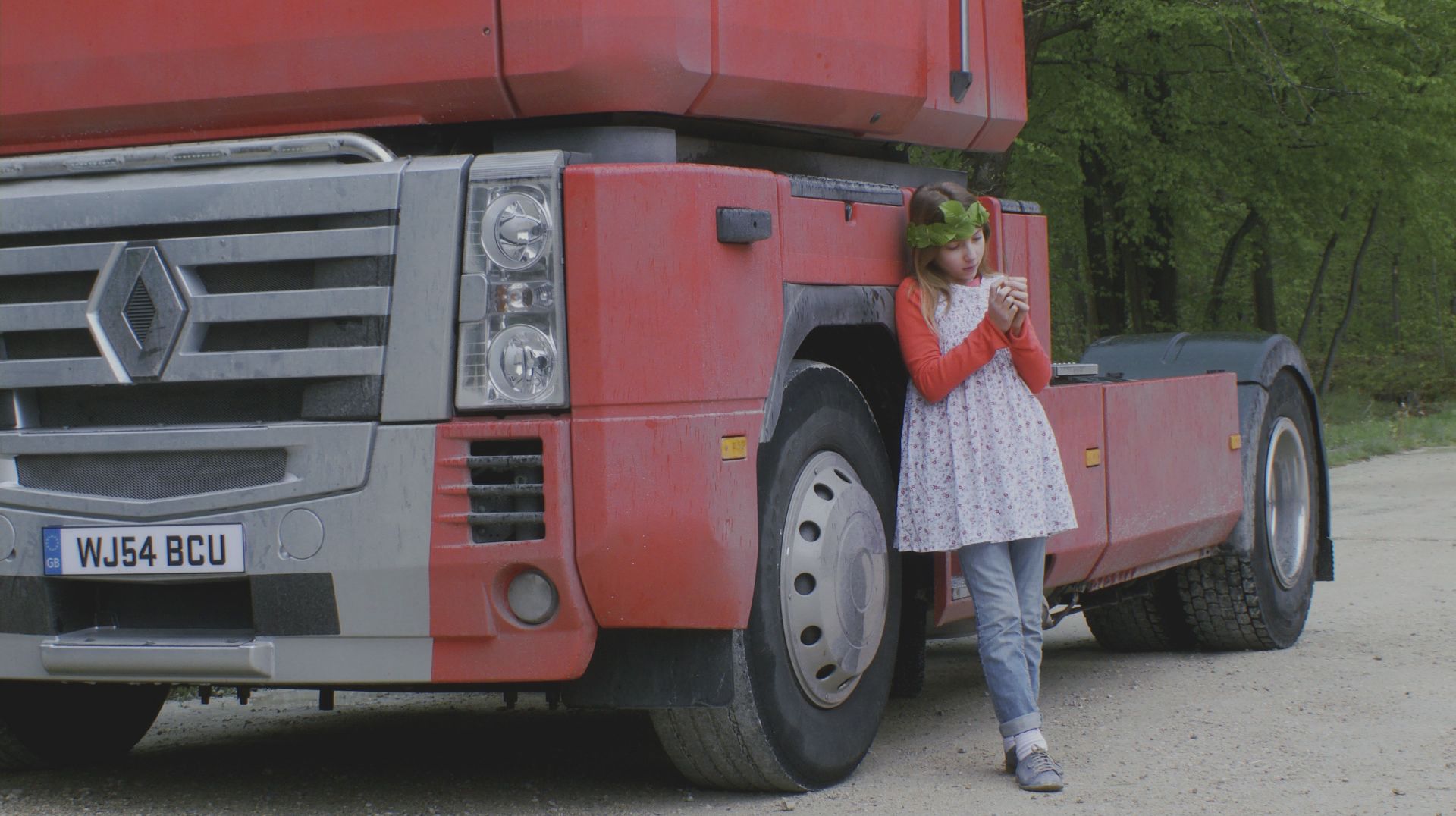 Celine ponders by a truck