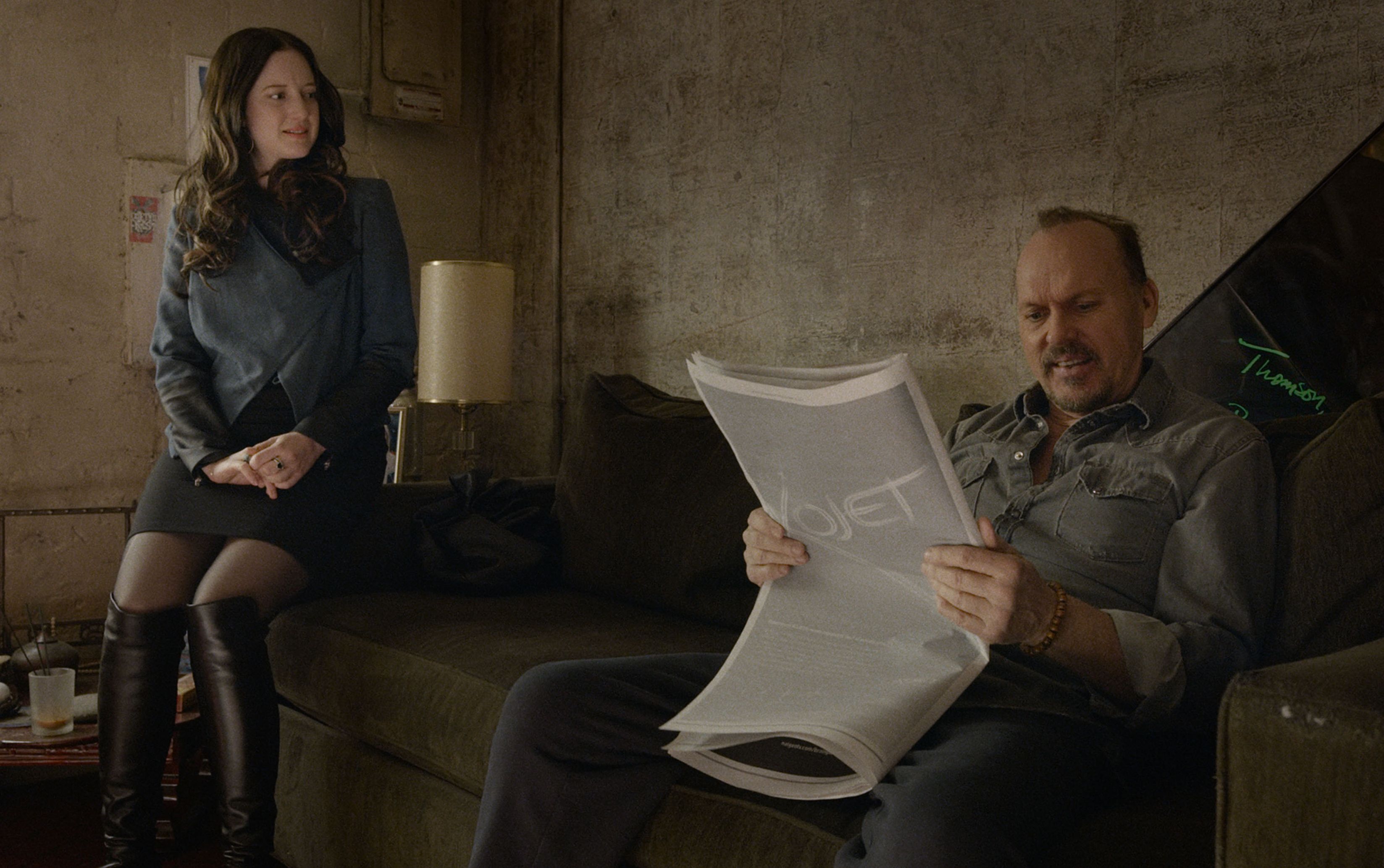 Andrea Riseborough and Michael Keaton reading the paper in B