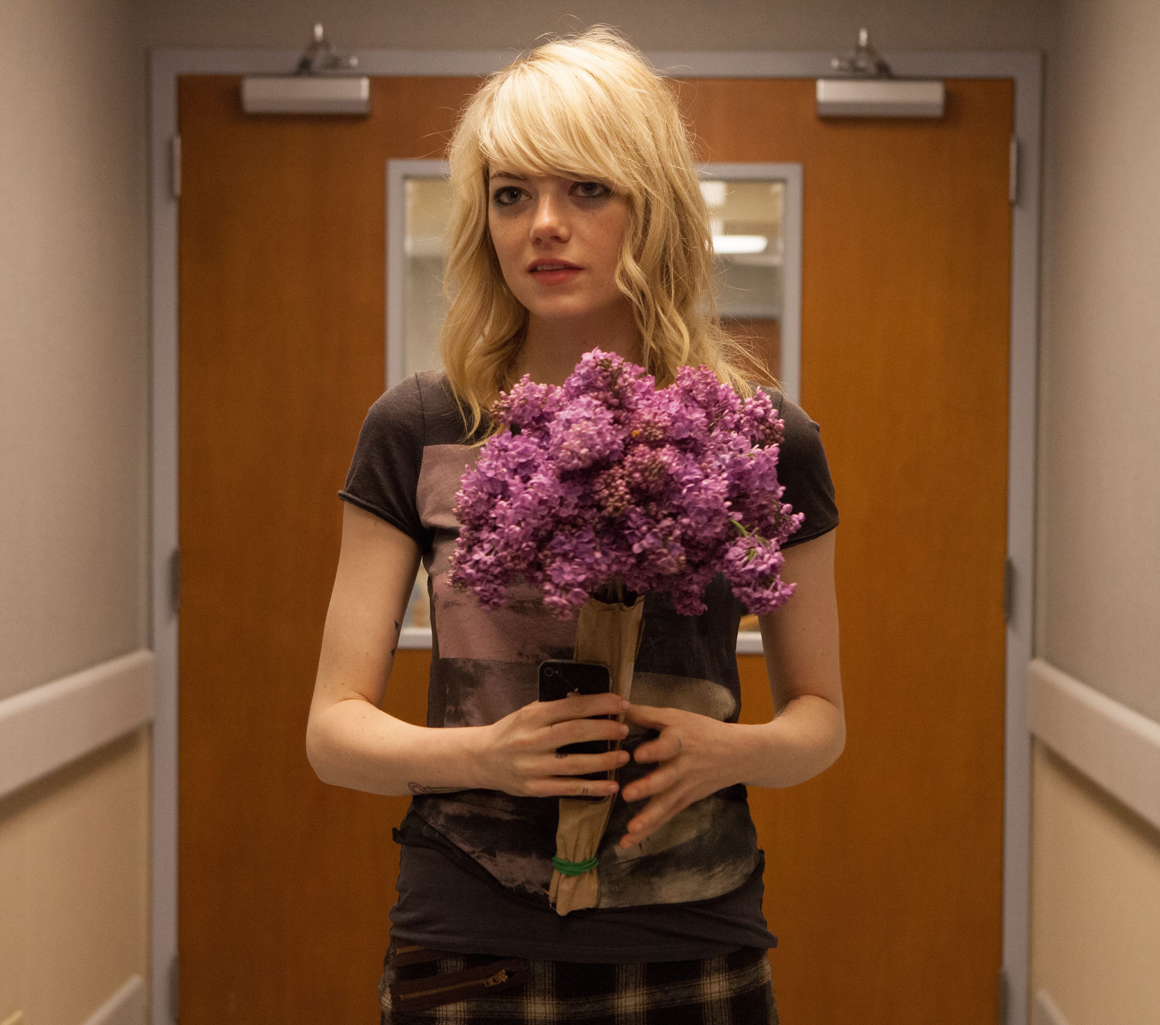 Emma Stone as Sam with flowers smirking - Birdman