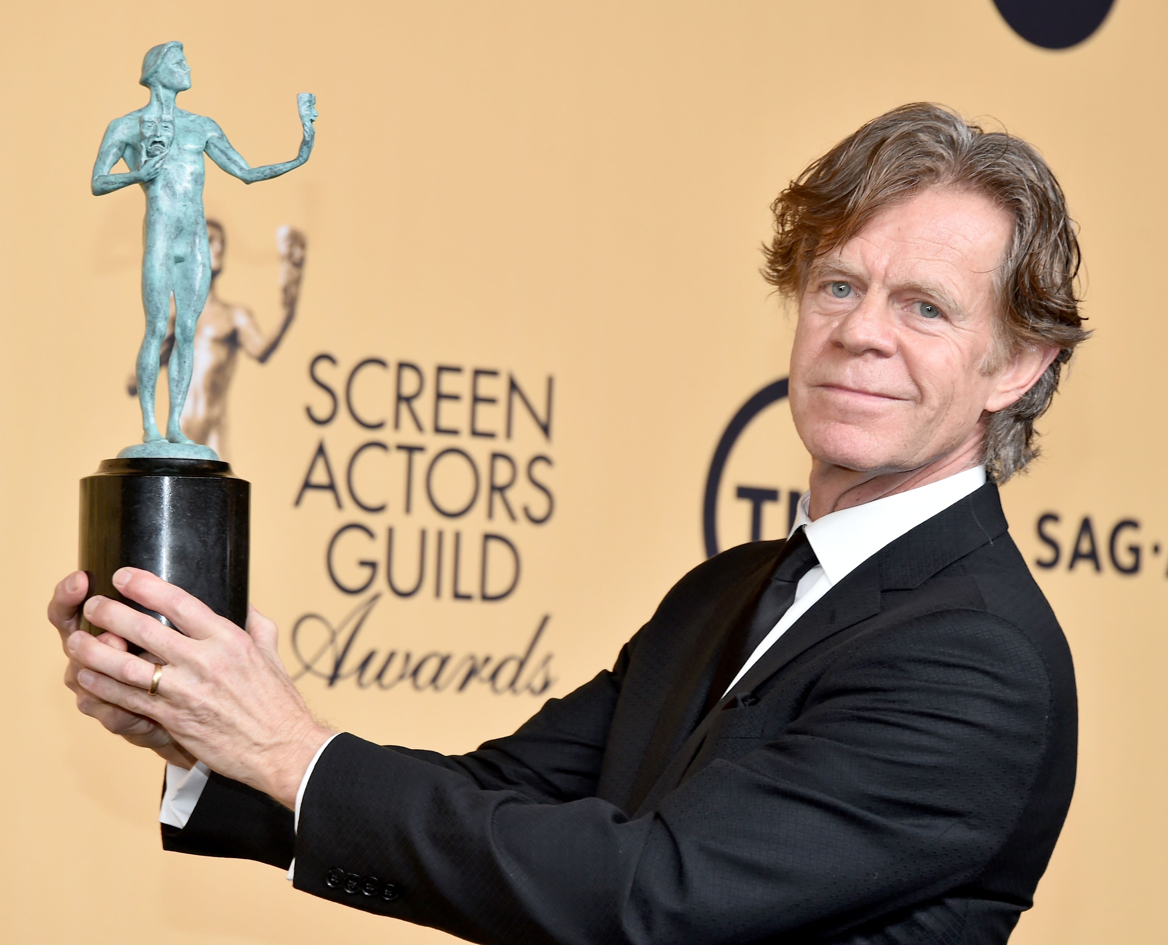 William H. Macy holding up his 2015 SAG Award