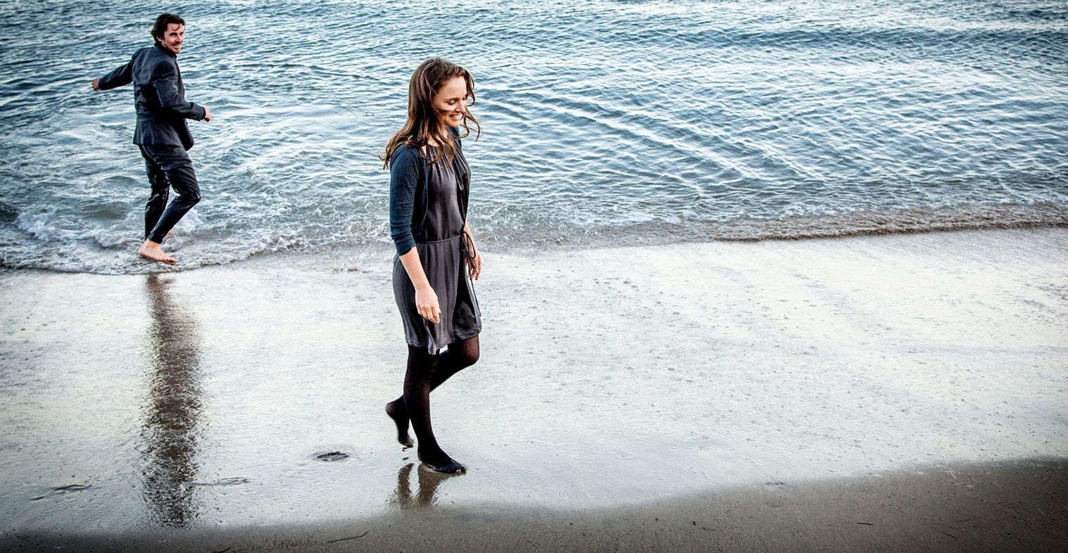 Christian Bale and Natalie Portman at the beach in Knight of