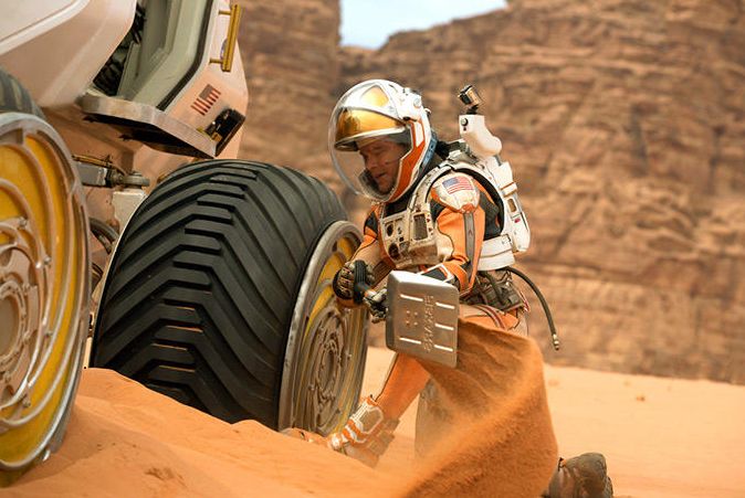 Matt Damon works on vehicle on Mars