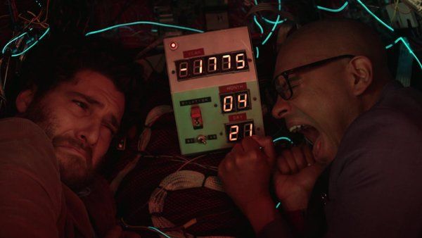 Adam Pally as Dan and Yassir Lester as Chris in the time tra