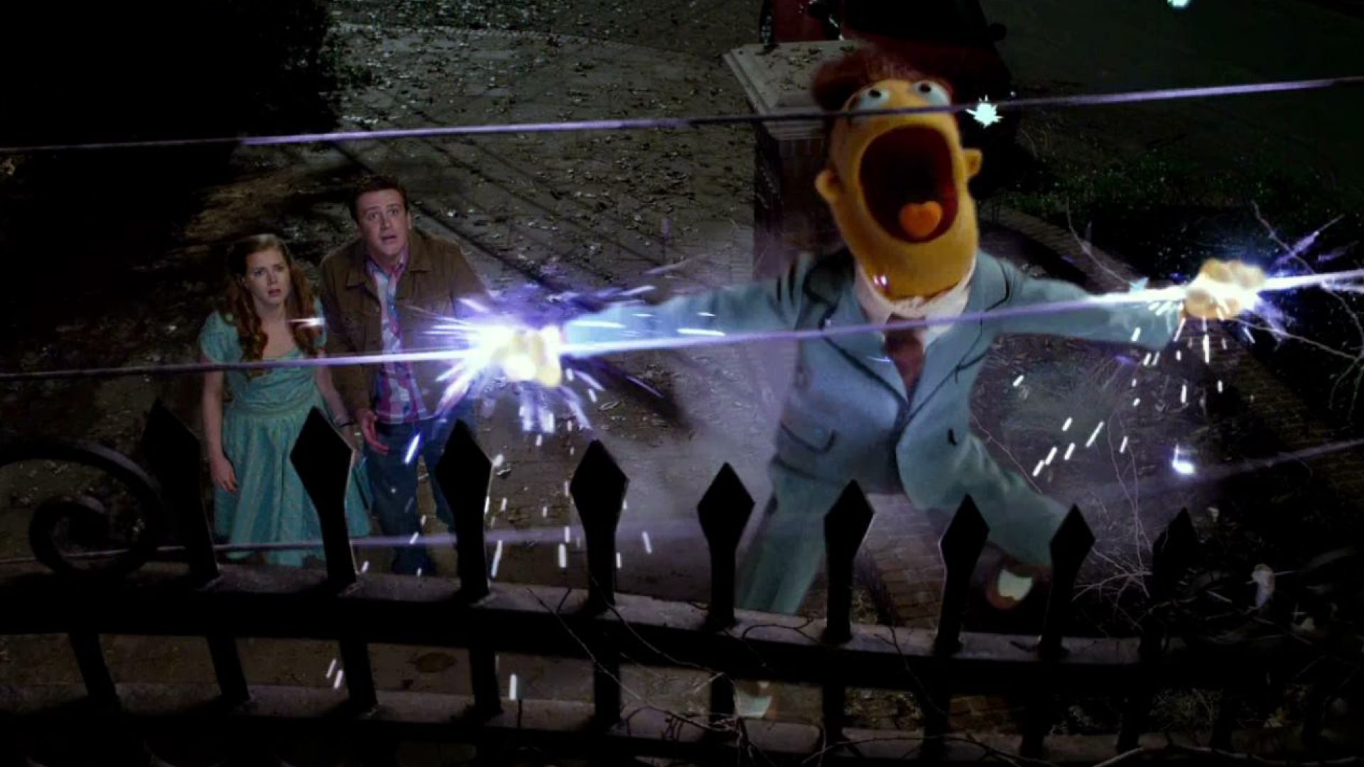 Jason Segel throws Walter onto an electric fence in The Muppets