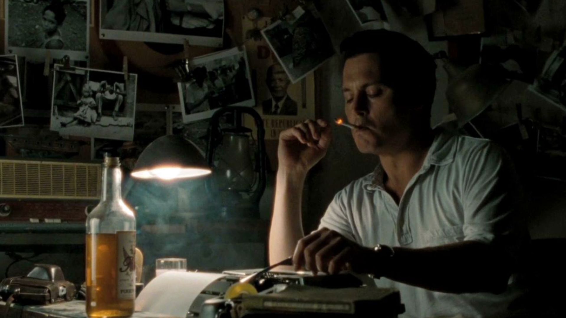 Johnny Depp smokes and drinks behind his typewriter in The Rum Diary